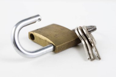 Beyaz bir tablo üzerinde pirinç asma kilit. Kilitleme ve hırsızlık karşı güvenliğini sağlamak için aksesuarlar. Beyaz arka plan.