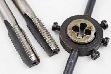 Aygıt içinde bir vida konuları yapmak için. Metal işleme aksesuarları. Beyaz arka plan.