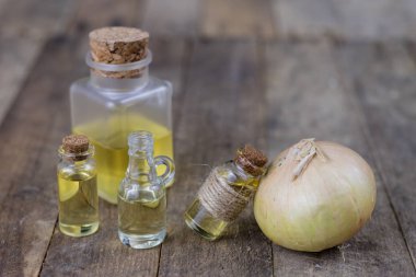 Soğan suyu ve sebzeler üzerinde ahşap bir masa. Ev yapımı şurubu grip tedavisi için. Koyu arka plan.