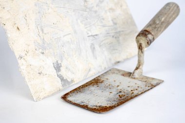 Kirli bir mala beyaz bir tablo. Masonlar ve inşaat işçileri için araçlar. Beyaz arka plan.