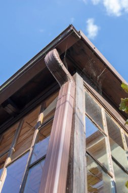 Yağmur suyu drenaj oluk. Binaya çatıdan yağmur suyu drenaj ile donatılmıştır. Yaz sezonu.