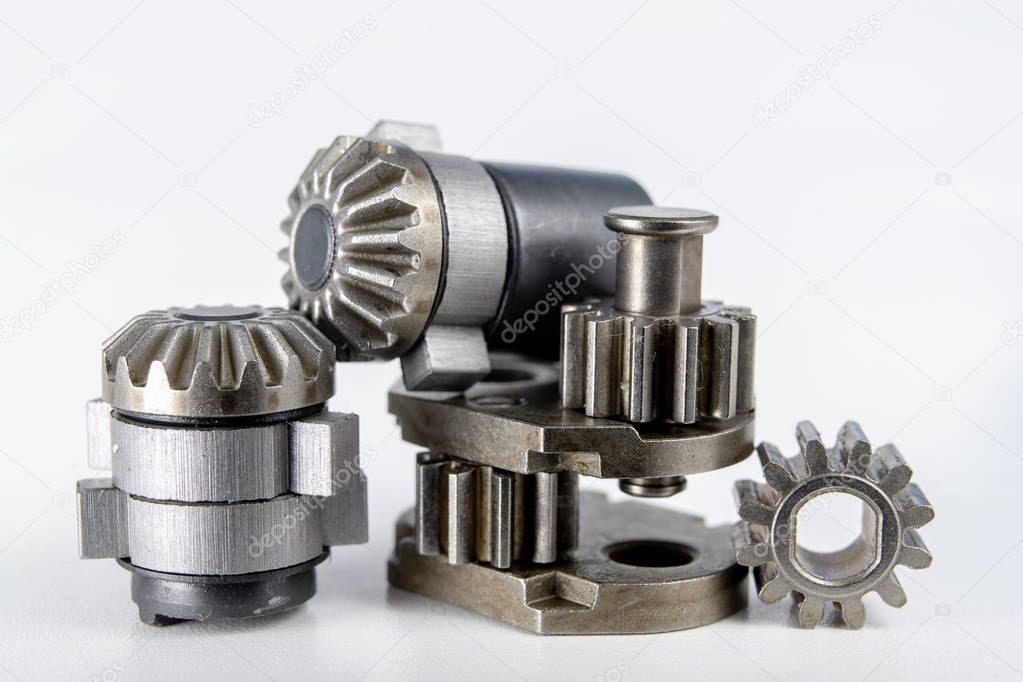 Wheels for mechanical gears on a white workshop table. Mechanical parts for mechanical devices. Light background.