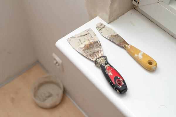 Applying putty to the wall in a new apartment. Renovation and painting of walls at home. Place - home farm.