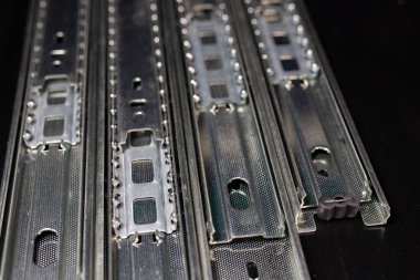 Doğrama ve mobilya yapıları için raylı sürgülü. Marangozluk aksesuar ahşap bir masa üzerinde. Koyu arka plan.