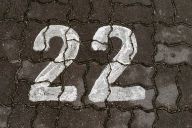 Parking space number painted on a paving stone. Parking signs for passenger cars. Season of the autumn clipart