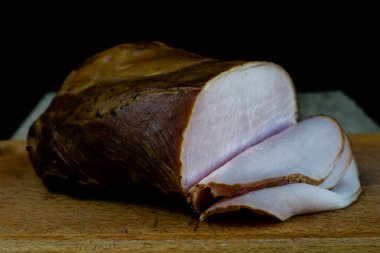 Ahşap Doğrama tahtası lezzetli füme jambon. Koyu arka plan.