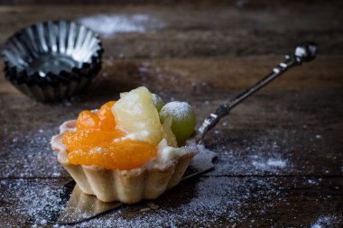 Lezzetli kek mutfak masasının üzerinde. Koyu arka plan.