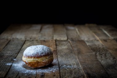 Ahşap bir masa üzerinde lezzetli çörek. Mutfakta hazırlanan lezzetli bir tatlı. Koyu arka plan.