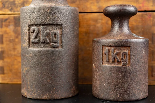 Old rusty metal weights for weighing products. Accessories for w