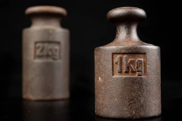 Old rusty metal weights for weighing products. Accessories for w