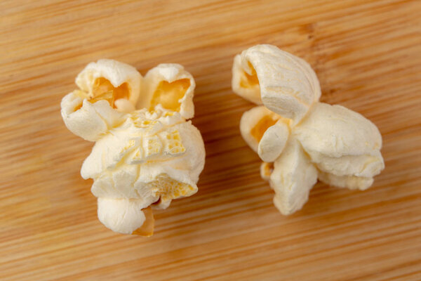 Попкорн на кухонном столе. Вкусные жареные зерна кукурузы
.