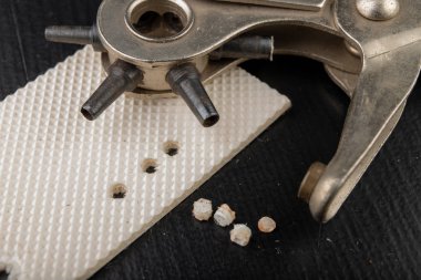 Eski bir zanaat atölyesinde çalışıyorum. Deride ve deride delikler açıyor.