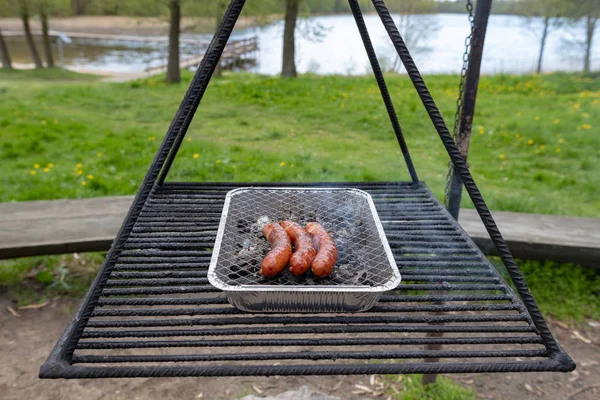 Stek korv på grillen. Förbereda en måltid på en Camping. — Stockfoto