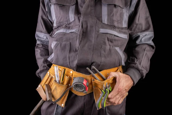 Workman in work clothes and tool belt. Production worker with a — Stock Photo, Image