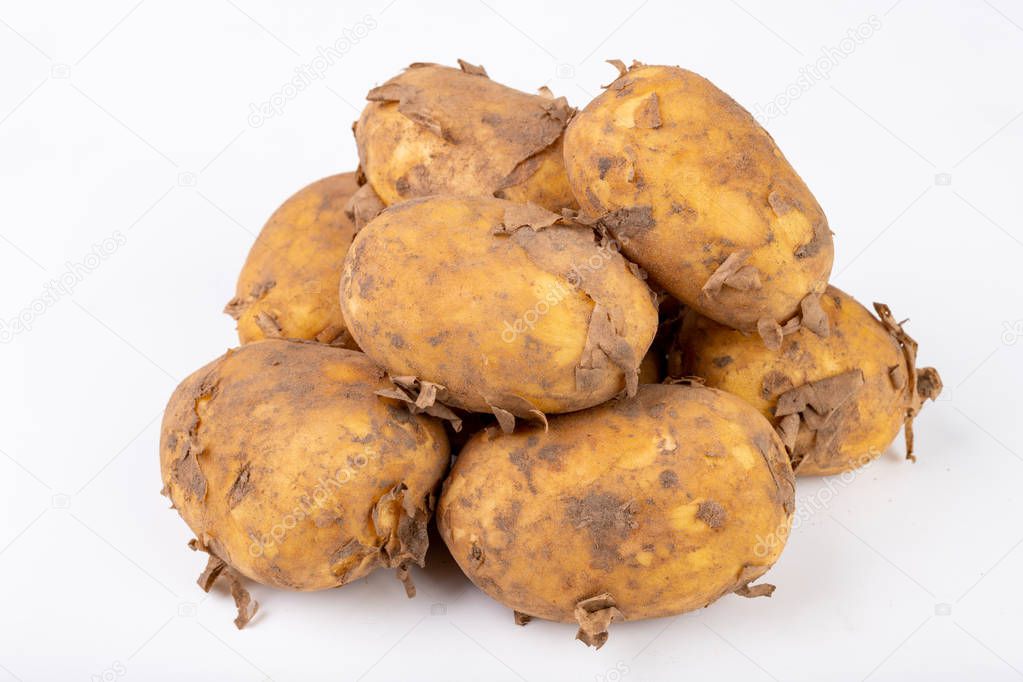 Young potatoes on a white kitchen table. Vegetables prepared for