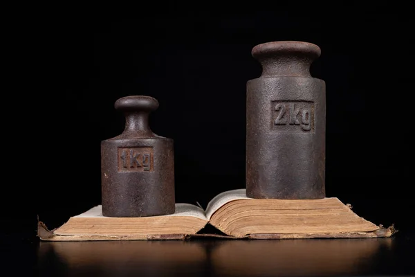 Old kilo weights on books. Old books and weighing machines.