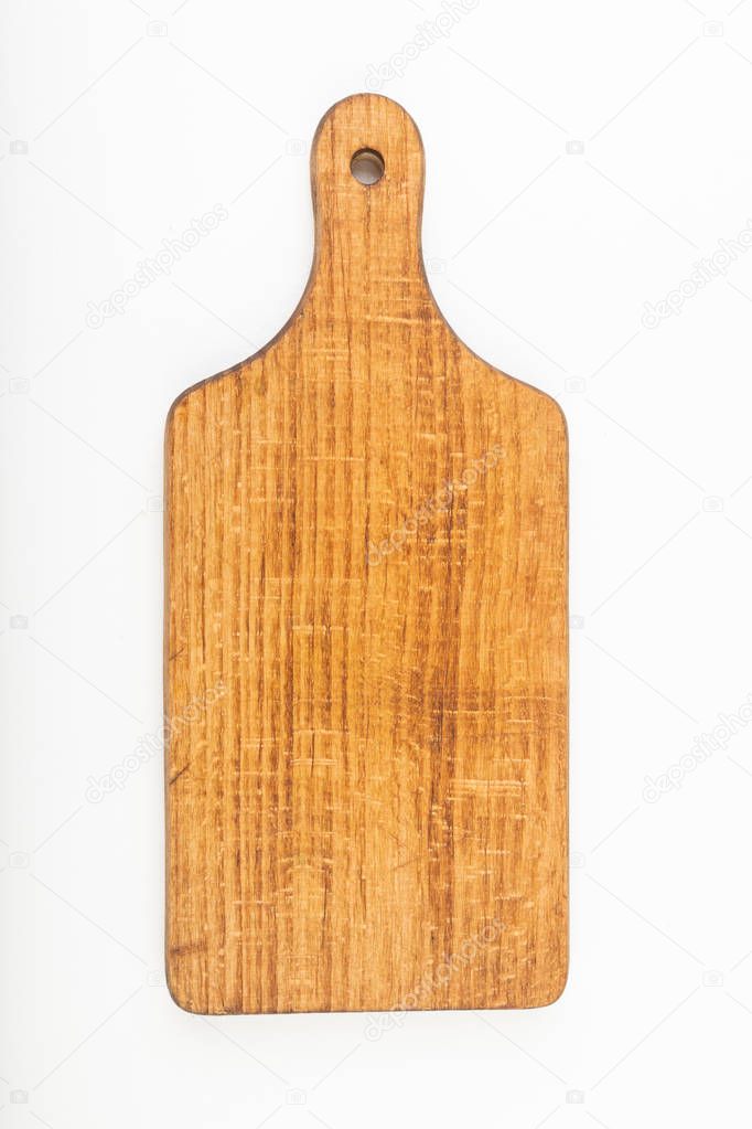 Dark wooden kitchen board on a white table. Old kitchen accessor