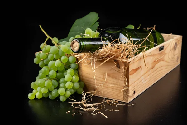 A bottle of wine in a wooden box. A tasty alcoholic drink in an