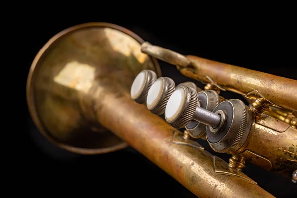Trumpet covered with patina on a dark table. — Stock Photo, Image