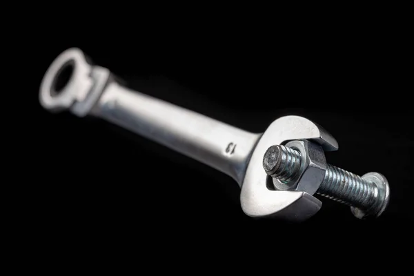 Nickel-plated nuts and wrenches on a workshop table. Tools in a — Stock Photo, Image