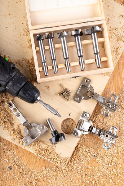 Installation of furniture hinges in chipboard. 