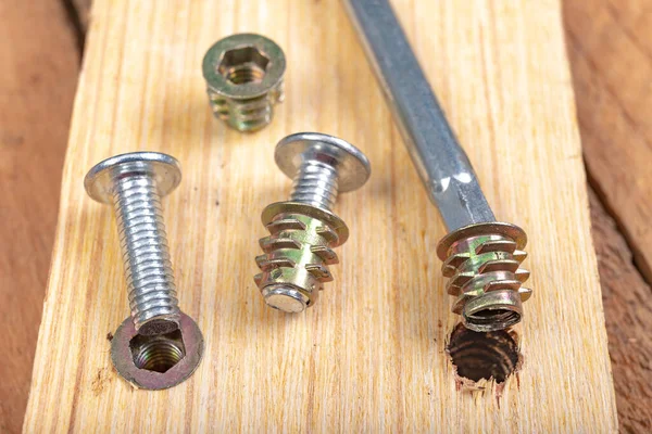 Special screws for joining wood. Carpentry accessories for building furniture. Workplace - workshop.