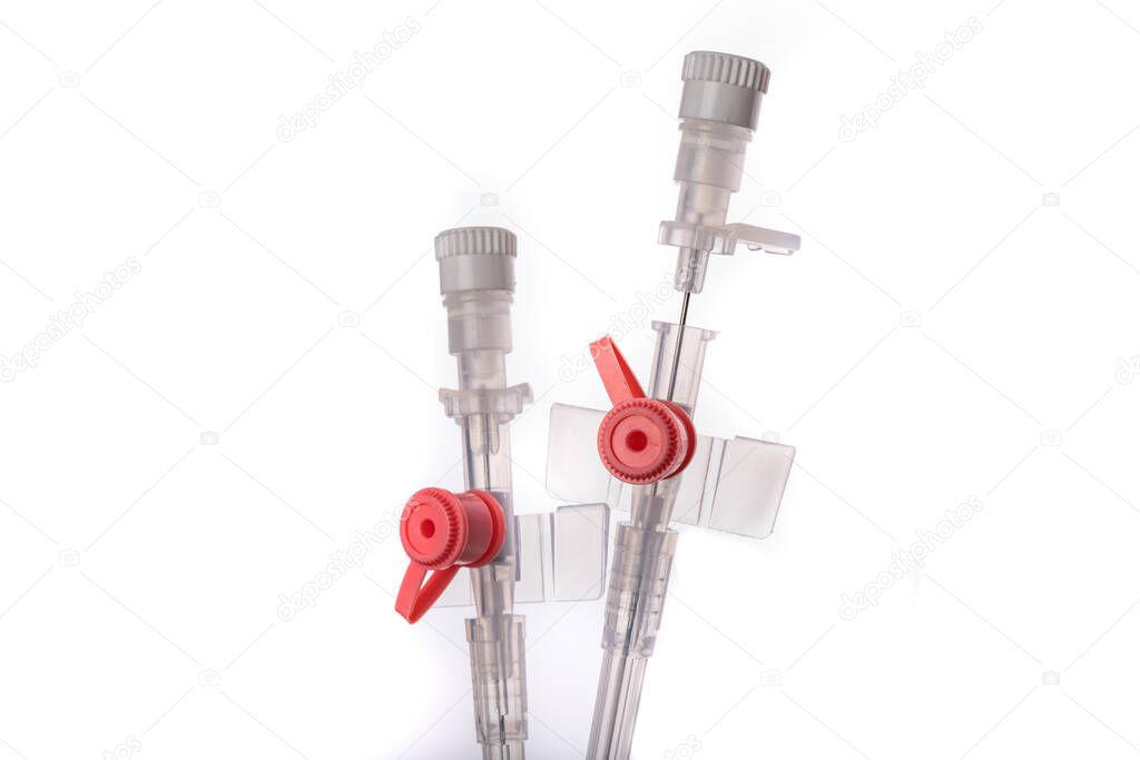 Medicinal venflon for the administration of intravenous fluids. Medical accessories needed in intensive care. Light background.