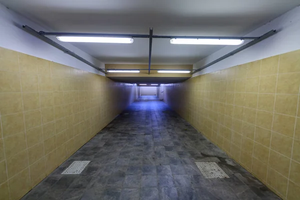 Underground passage to the train station platform. Infrastructure for traveling passengers. Autumn season.