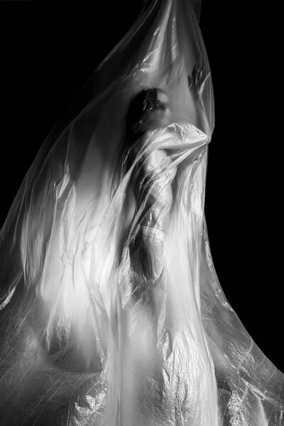 Slim girl dressed only in underwear emotionally posing, wrapped 