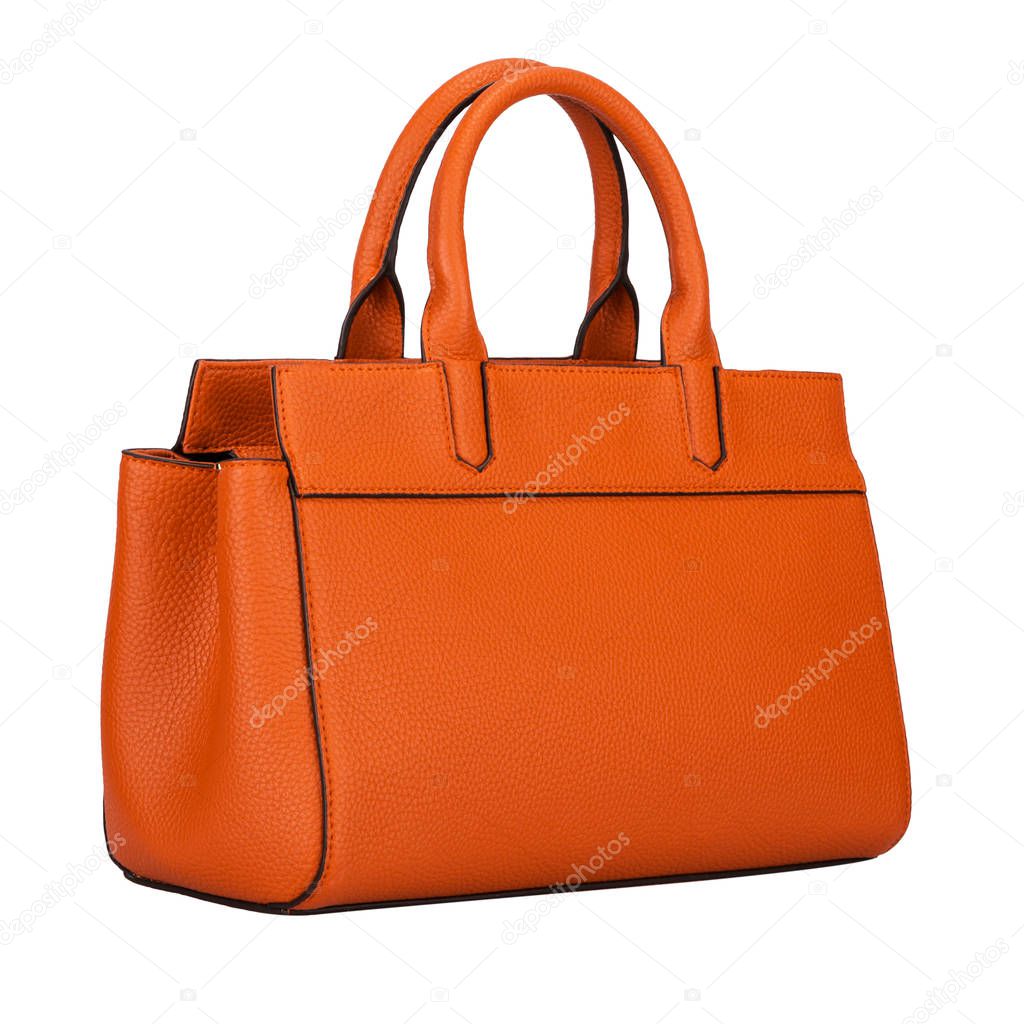 Fashionable light orange classic women's handbag of solid leather with embossed stripes side view isolated on white background