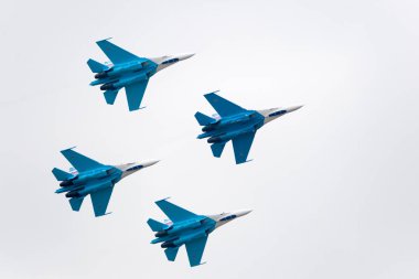 Russia, Zhukovsky - August 22, 2009: The Air Show. Military aircraft showing a group of aerobatics in the sky clipart