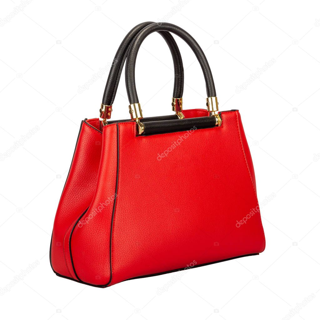 Fashionable red classic ladies handbag of solid textured leather with black elegant handles and inserts and golden accessories of a three-apartment type, isolated on white background