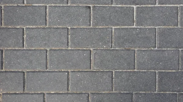 Kaldırım dikdörtgen gri cobblestones. Üstten görünüm