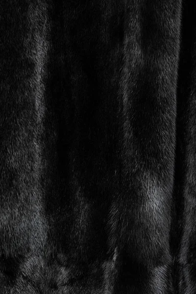 Texture of natural black shiny fur with beautiful wavy folds — Stock Photo, Image