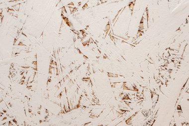 Rastgele düzenlenmiş, iyi detaylandırılmış deseni olan, açık bej rengine boyanmış baskılı talaşlardan oluşan bir tahta.