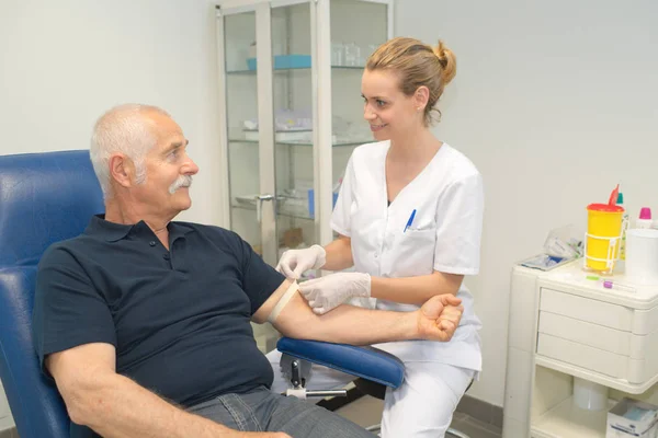 Médico fêmea coleta de sangue de pacientes para teste — Fotografia de Stock