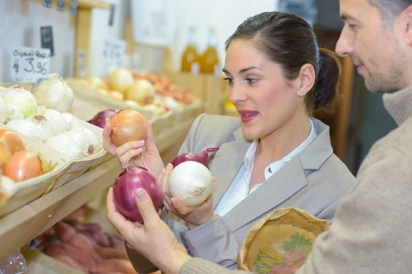 Mujer comparando variedades de cebollas —  Fotos de Stock