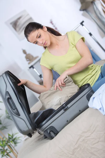 Female preparing suitcase with casual female clothes — Stock Photo, Image