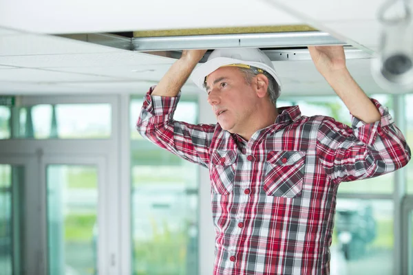 Man holding a gypsum board figured cut — Stock Photo, Image