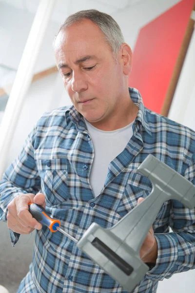 Male worker holding screwdriver — Stock Photo, Image