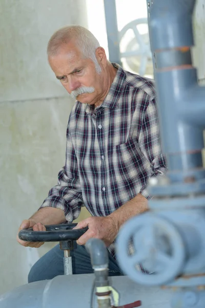 Senior worker climbing up for maintenance works — Stock Photo, Image