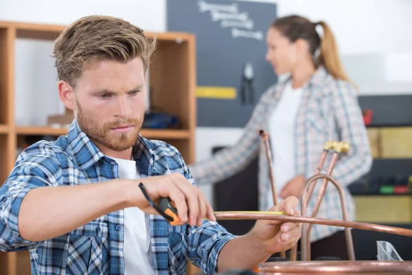 Plumber screwing nut of pipe with wrench — Stock Photo, Image