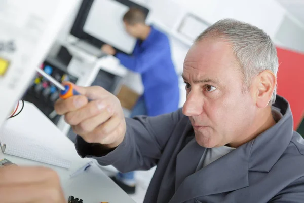 Male technician machinist worker adjusting elevator mechanism — Stock Photo, Image