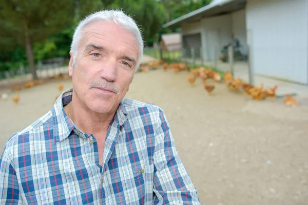 Poultry farmer posing and man — Stock Photo, Image