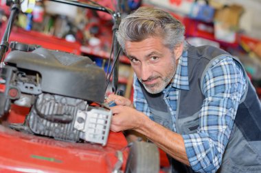 a man assemble brush cutter engine clipart