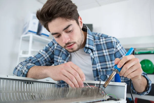 Man fixing radiator soldering parts — Stock Photo, Image