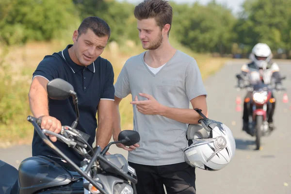 teacher and student on a motorbike test