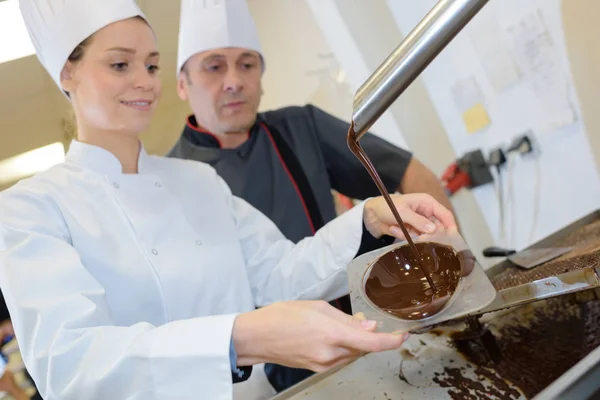 Chef team in restaurant kitchen with dessert working together — Stock Photo, Image
