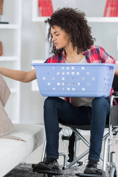 Disabled pretty woman doing her laundry — Stock Photo, Image