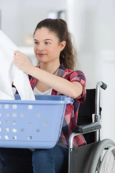 Young woman folding the clothes — Stock Photo, Image